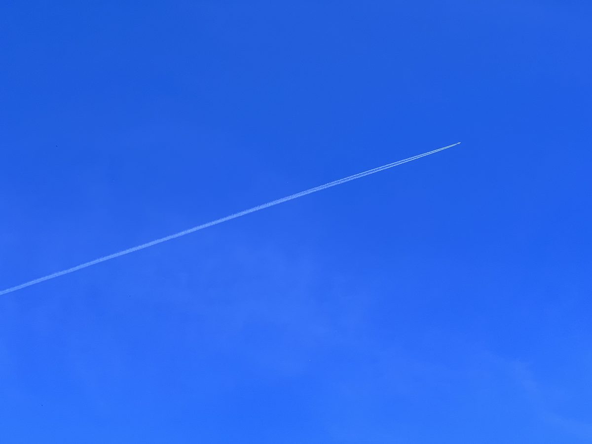 Aircraft flying overhead against a clear blue sky
