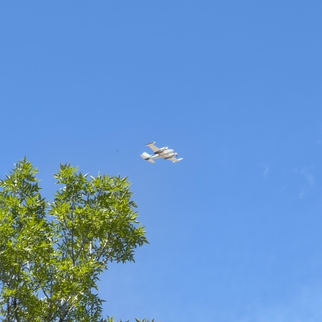 Cessna 310 twin N3162L overhead near Broomfield Colorado on a clear spring day
